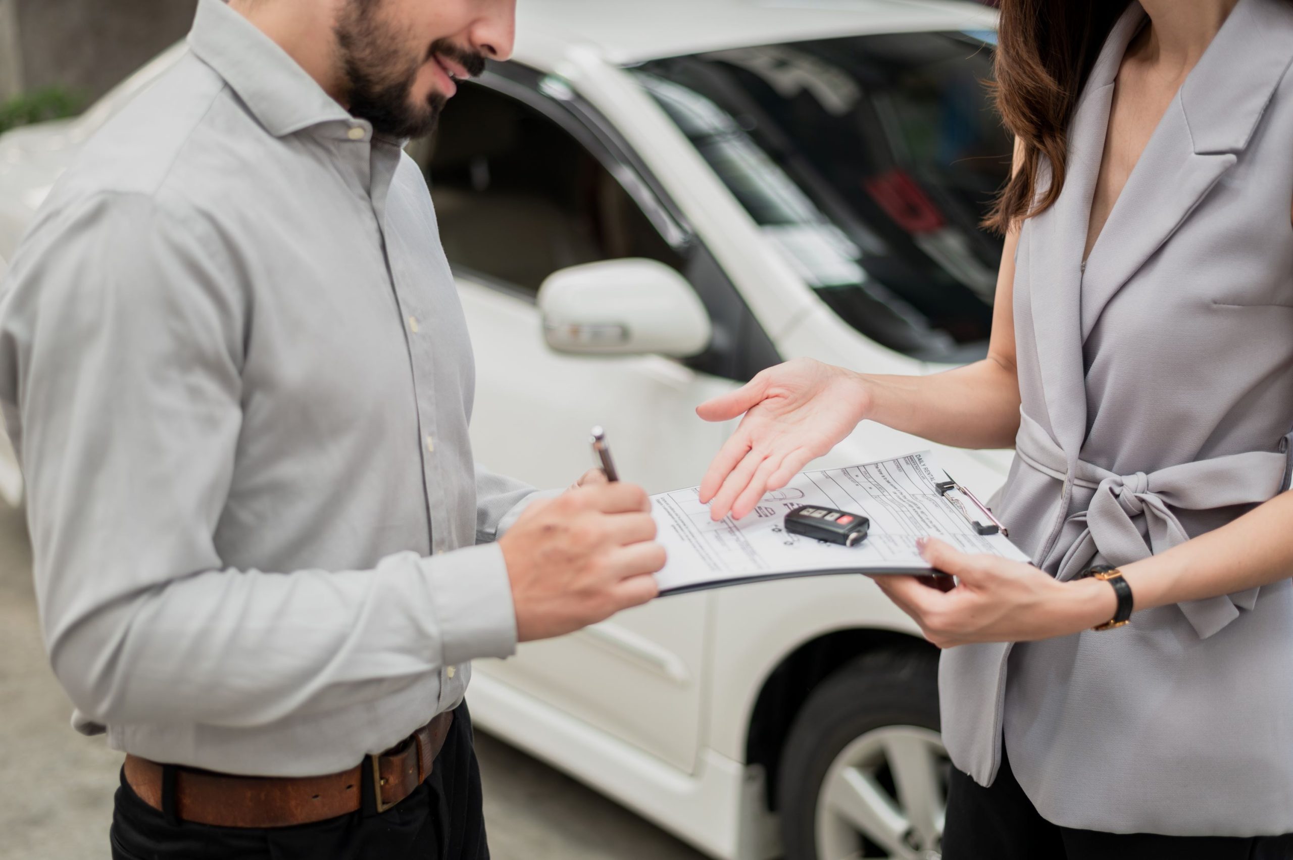 a person talking to a car dealership about their car maintenance service package