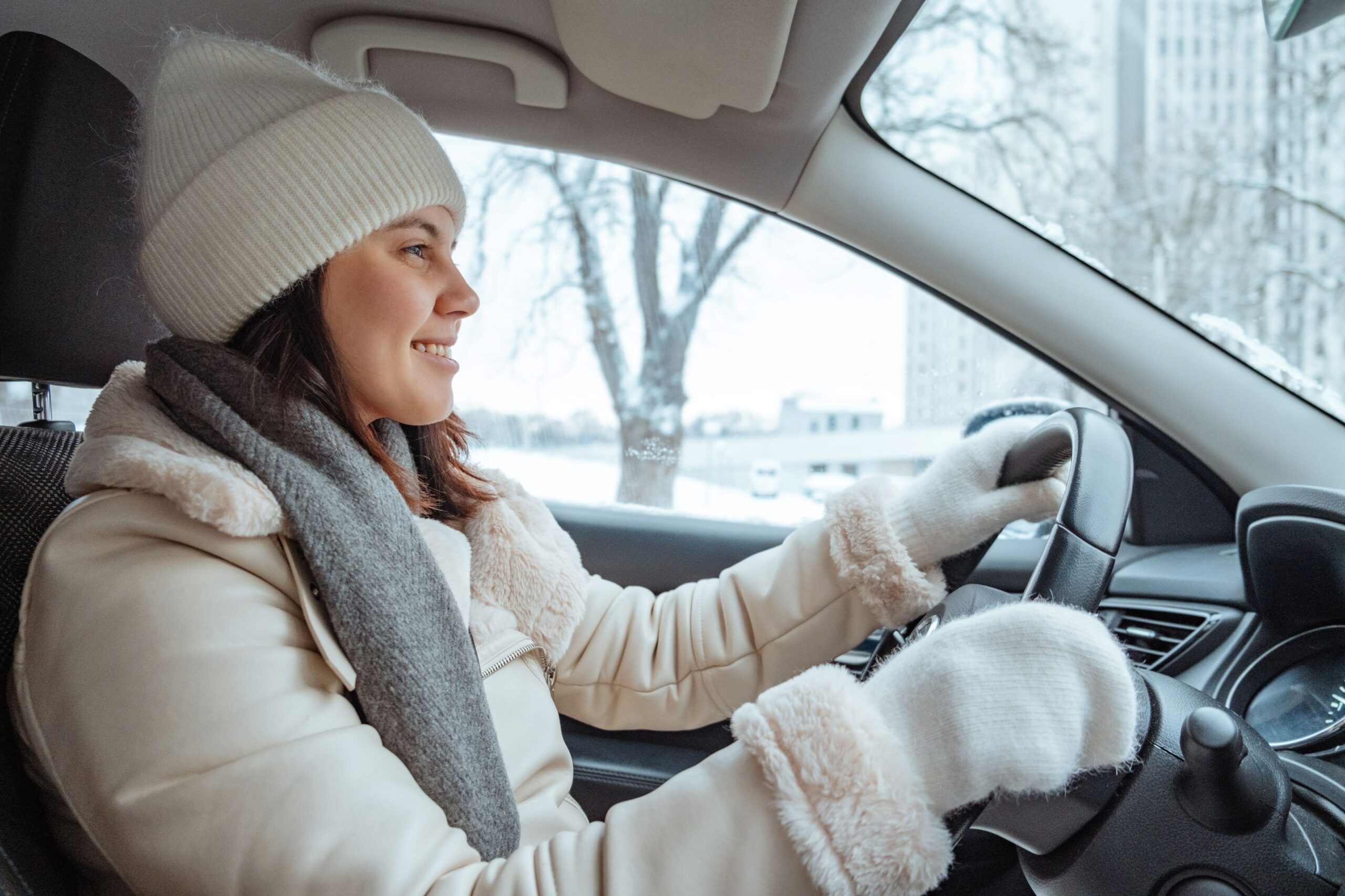 woman driving around during winter feeling good because she has a car safety kit